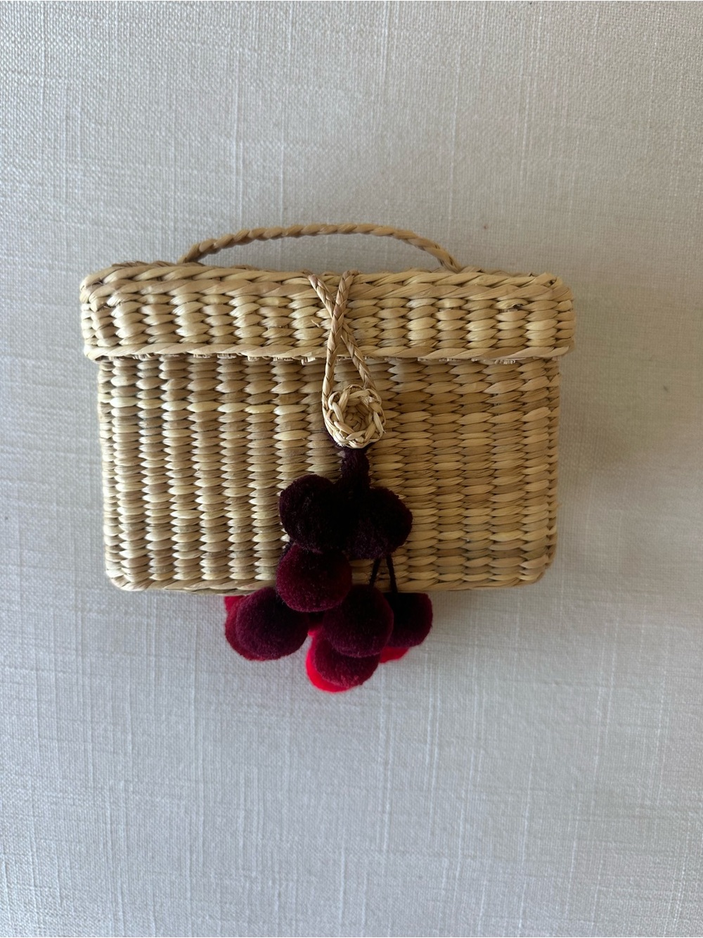 Nannacay Woven Straw Crossbody Bag with Burgundy Pom Pom Accent